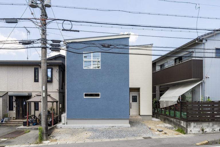 ブルーと白の外観が印象的な片流れ屋根の家